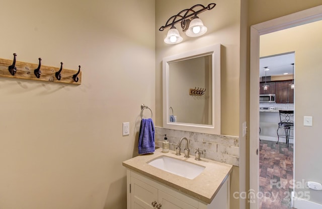 bathroom with vanity and tasteful backsplash