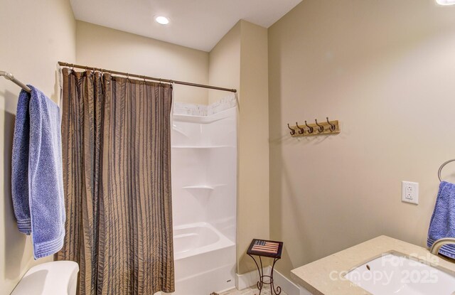full bathroom featuring toilet, shower / tub combo, and a sink