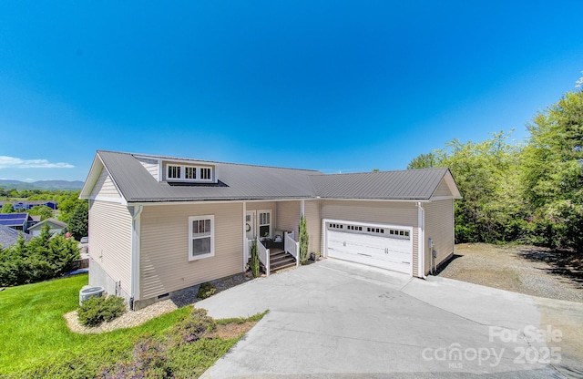 view of front of house with a porch, an attached garage, crawl space, driveway, and metal roof