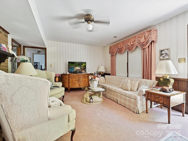 carpeted living room featuring wallpapered walls and a ceiling fan