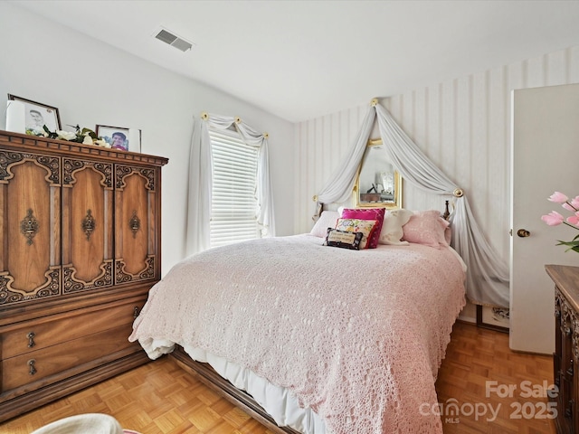 bedroom featuring visible vents and wallpapered walls