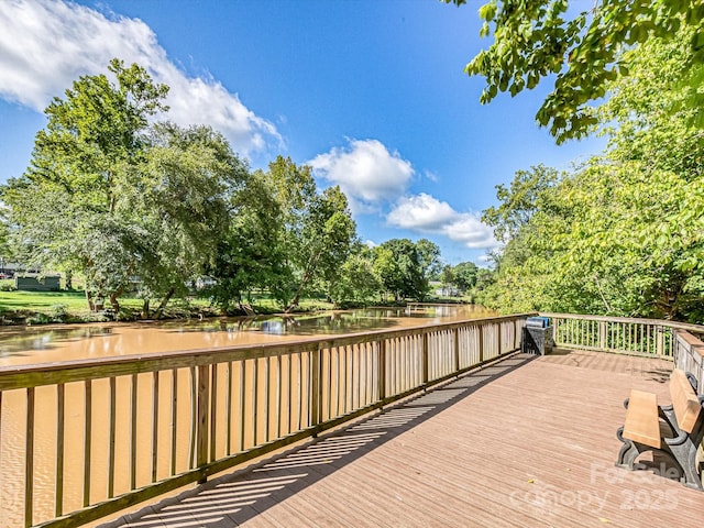 wooden deck featuring a water view