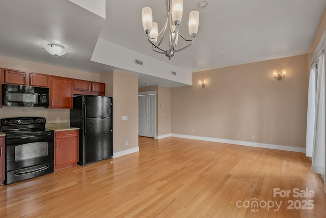 kitchen featuring brown cabinetry, black appliances, visible vents, baseboards, and light wood-style floors