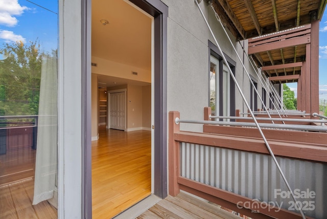 exterior space with stucco siding and a balcony