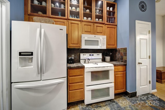 kitchen with white appliances, glass insert cabinets, backsplash, brown cabinets, and baseboards