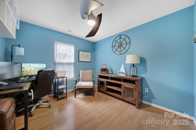 office space featuring wood finished floors, baseboards, and a textured ceiling