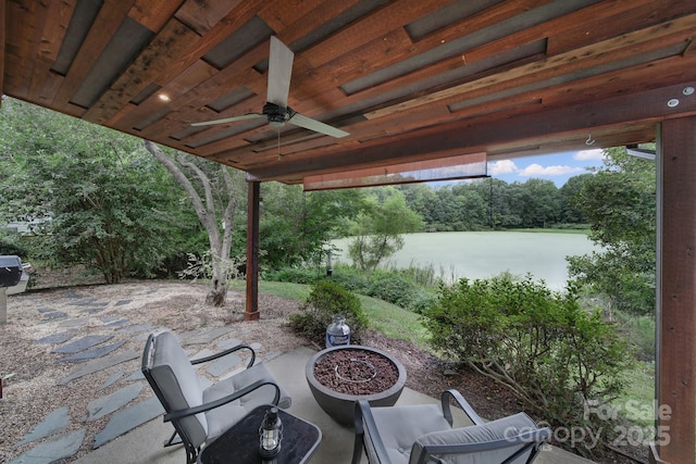 view of patio / terrace featuring a ceiling fan and a water view