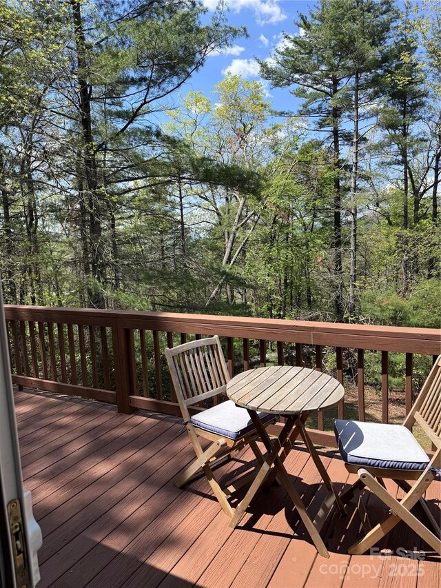 wooden deck featuring outdoor dining area
