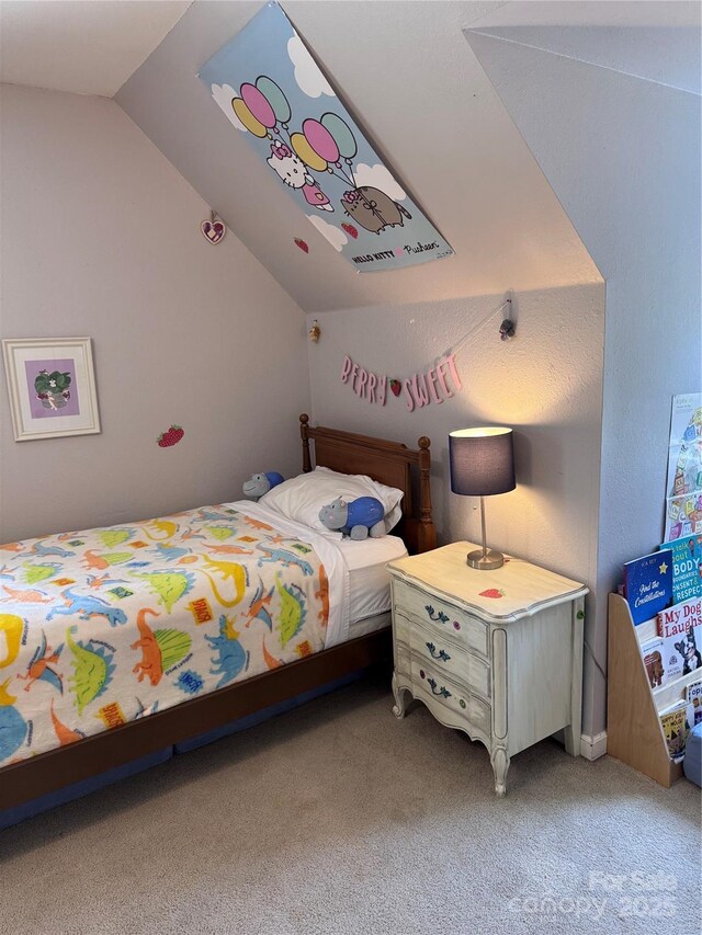 carpeted bedroom with vaulted ceiling
