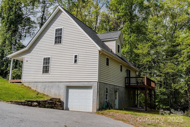 76 Overlook Pointe Dr, Spruce Pine, NC 28777 - view of side of property with an attached garage, a shingled roof, and a deck