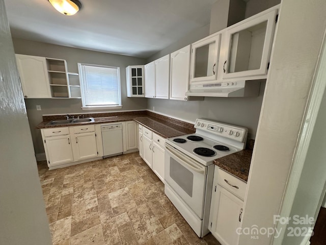 kitchen featuring a sink, white appliances, white cabinetry, stone finish flooring, and under cabinet range hood