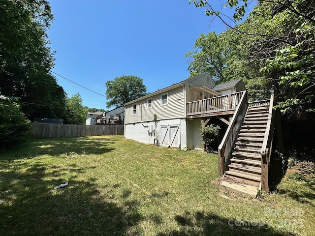 view of yard featuring stairs, fence, and a wooden deck