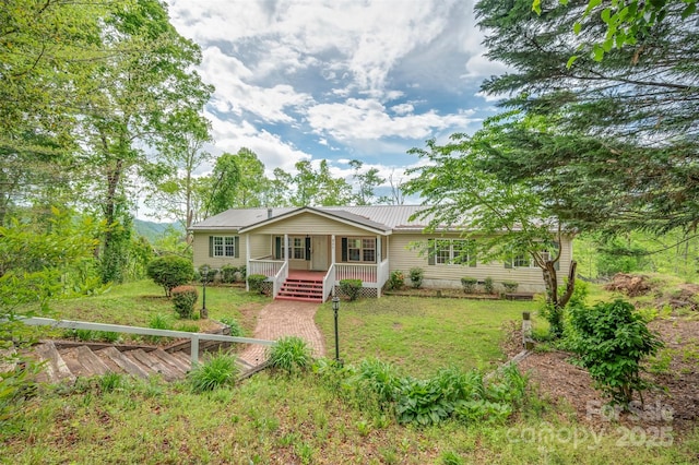257 River Crest Dr, Flat Rock, NC 28731 - view of front of home with a front lawn, metal roof, and covered porch