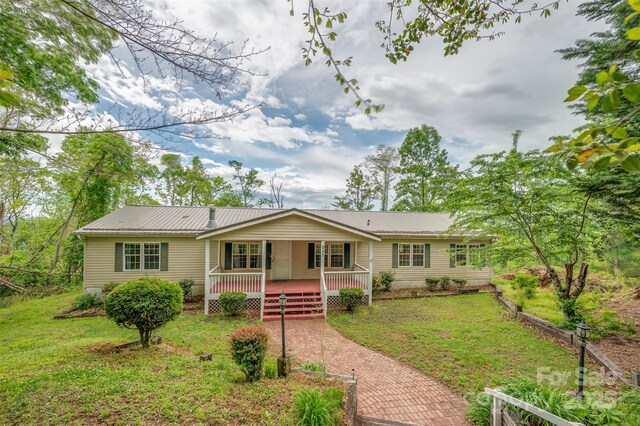 257 River Crest Dr, Flat Rock, NC 28731 - view of front facade featuring covered porch, metal roof, and a front yard