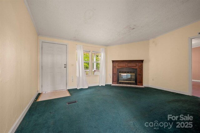 257 River Crest Dr, Flat Rock, NC 28731 - unfurnished living room with a textured ceiling, a glass covered fireplace, baseboards, and visible vents
