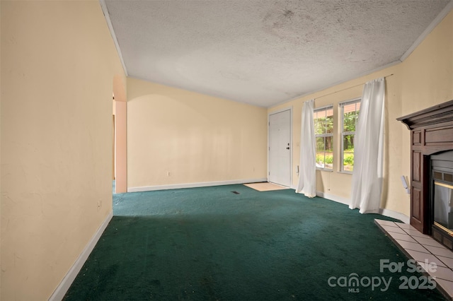 257 River Crest Dr, Flat Rock, NC 28731 - unfurnished living room featuring baseboards, a textured ceiling, a tiled fireplace, and carpet