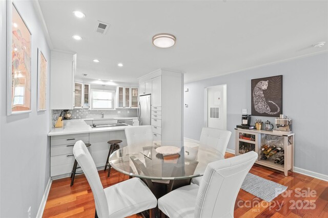 dining area featuring baseboards, recessed lighting, light wood-style flooring, and visible vents