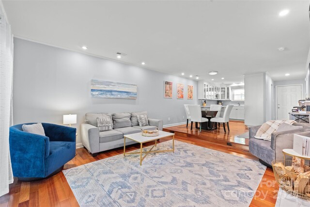 living area with recessed lighting and wood finished floors