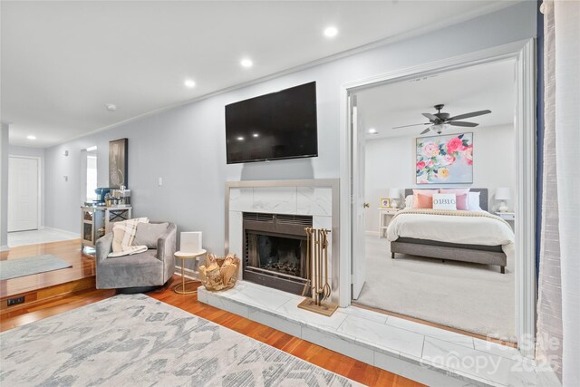 interior space featuring recessed lighting, ceiling fan, wood finished floors, and a fireplace