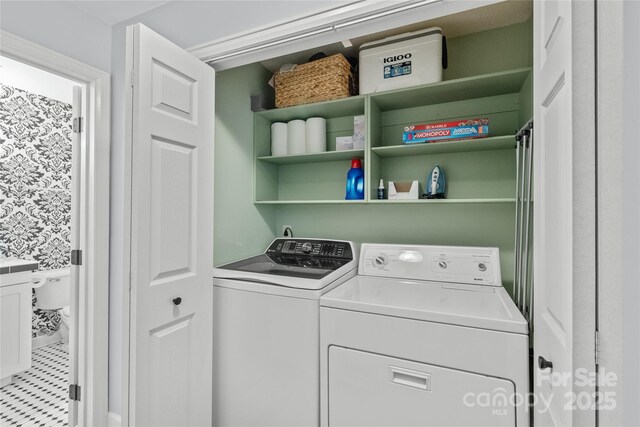 clothes washing area with laundry area and washer and dryer