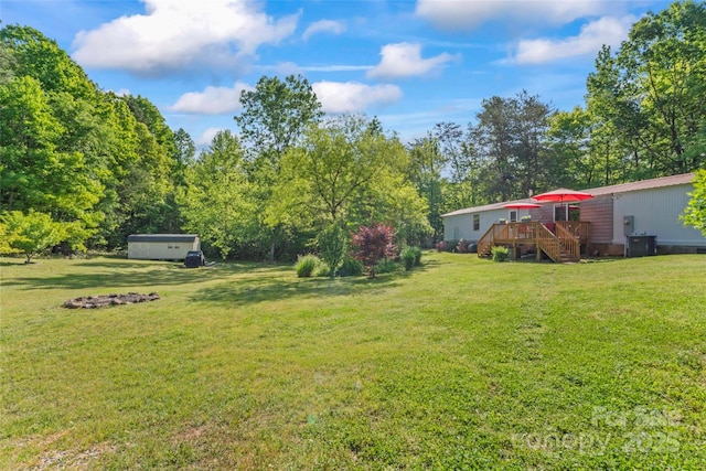 743 Dream Ln, Salisbury, NC 28146 - view of yard featuring stairway, a deck, central AC, and an outbuilding