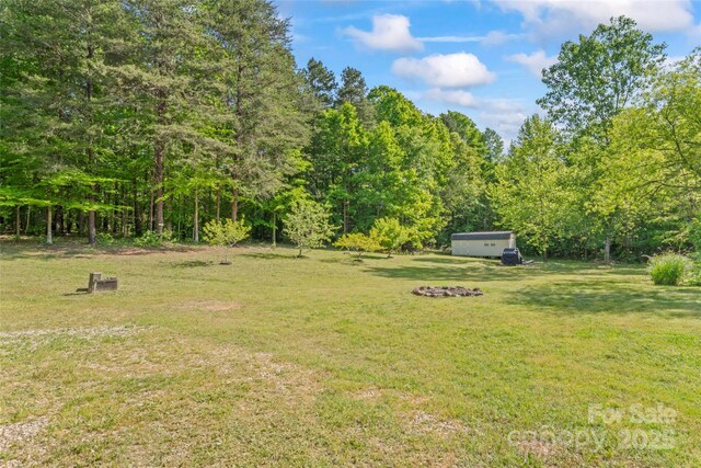 743 Dream Ln, Salisbury, NC 28146 - view of yard featuring a view of trees and an outdoor structure
