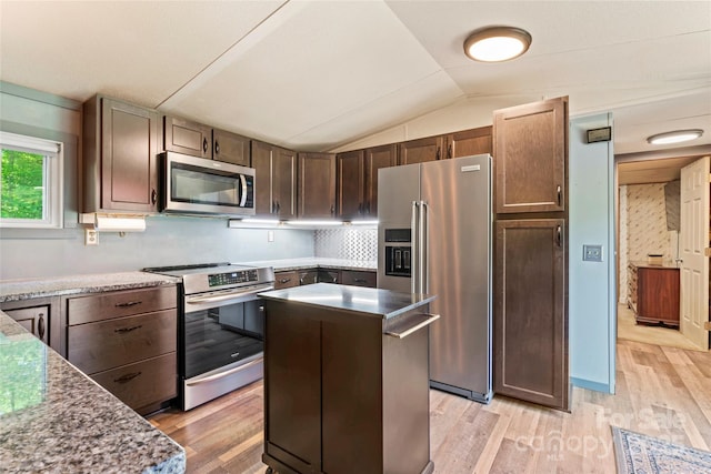 743 Dream Ln, Salisbury, NC 28146 - kitchen featuring lofted ceiling, a kitchen island, dark brown cabinets, light wood-style floors, and stainless steel appliances