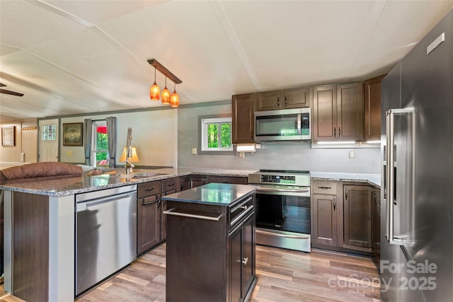 743 Dream Ln, Salisbury, NC 28146 - kitchen with a peninsula, appliances with stainless steel finishes, a wealth of natural light, and light wood finished floors