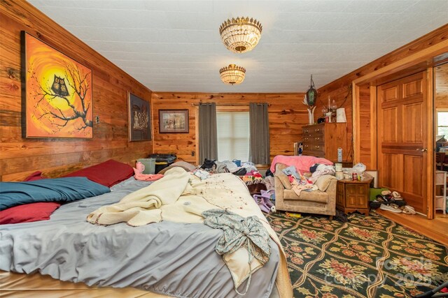 bedroom featuring wooden walls and wood finished floors