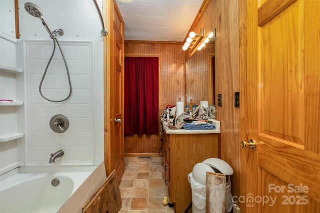 full bath with wooden walls and bathtub / shower combination