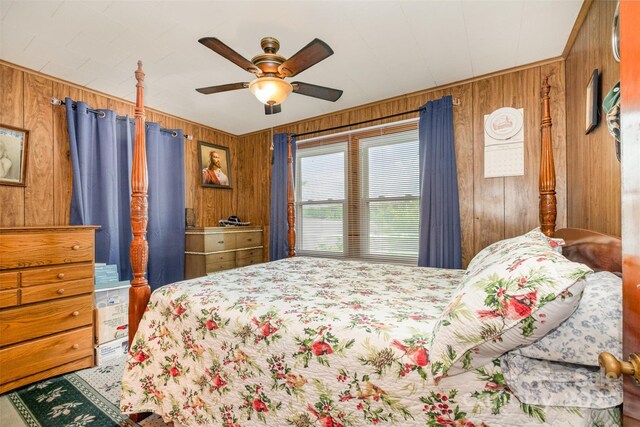 bedroom featuring wooden walls and ceiling fan