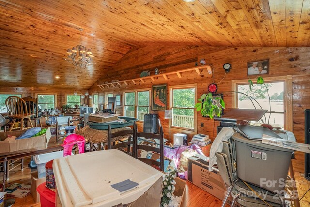interior space with wood walls, vaulted ceiling, wood ceiling, and wood finished floors