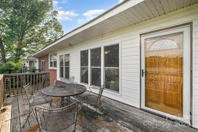 wooden terrace featuring outdoor dining area