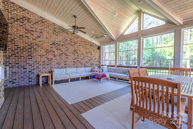 sunroom / solarium featuring ceiling fan, an outdoor living space, a healthy amount of sunlight, and beamed ceiling