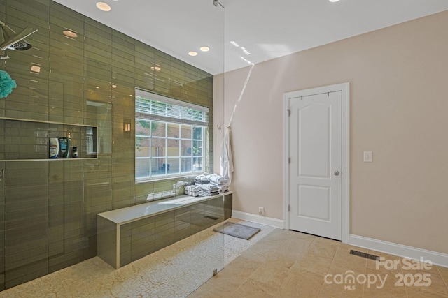 bathroom with visible vents, tile patterned flooring, a tile shower, baseboards, and recessed lighting