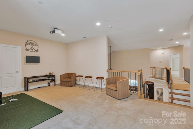 interior space with recessed lighting, carpet, baseboards, and an upstairs landing
