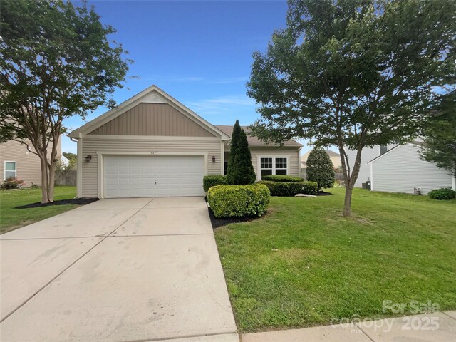 ranch-style home featuring driveway, a front yard, and a garage