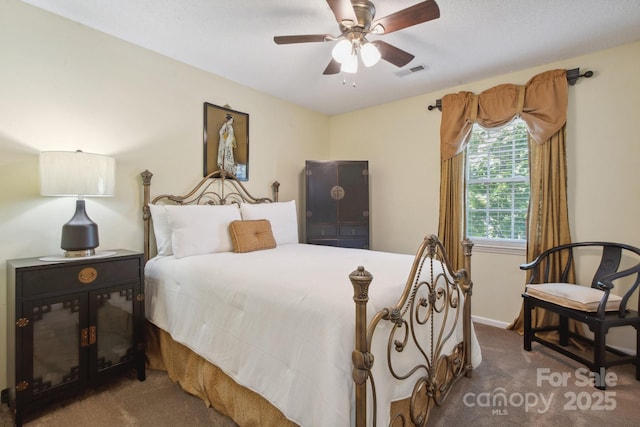 carpeted bedroom featuring baseboards, a ceiling fan, and visible vents