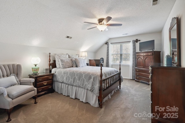 bedroom with visible vents, a textured ceiling, lofted ceiling, and light carpet