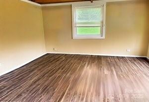 374 Queens Dr SW, Concord, NC 28025 - empty room with wood finished floors and baseboards