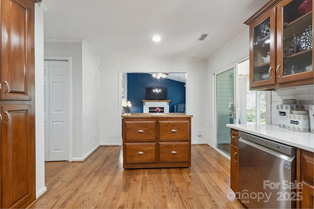 374 Queens Dr SW, Concord, NC 28025 - kitchen featuring stainless steel dishwasher, ornamental molding, light wood finished floors, baseboards, and light countertops