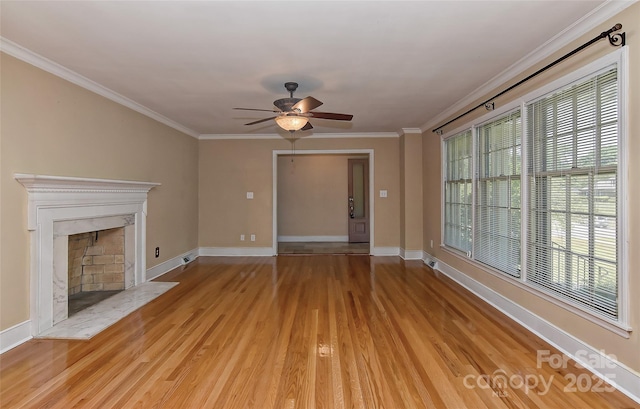 385 Gum Branch Rd, Charlotte, NC 28214 - unfurnished living room featuring crown molding, baseboards, a ceiling fan, and light wood finished floors