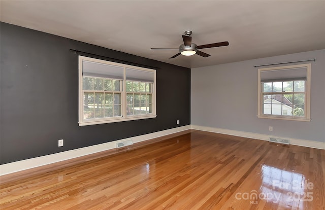 385 Gum Branch Rd, Charlotte, NC 28214 - unfurnished room featuring baseboards, ceiling fan, wood finished floors, and visible vents
