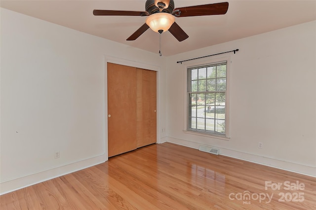 385 Gum Branch Rd, Charlotte, NC 28214 - unfurnished bedroom with ceiling fan, visible vents, baseboards, a closet, and light wood-style floors