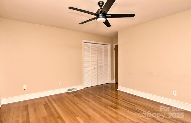 385 Gum Branch Rd, Charlotte, NC 28214 - unfurnished bedroom with baseboards, visible vents, wood finished floors, and a closet