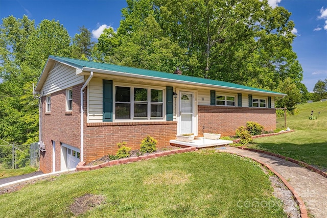 111 Baxter St, Morganton, NC 28655 - view of front of home featuring a garage, fence, a front yard, and brick siding