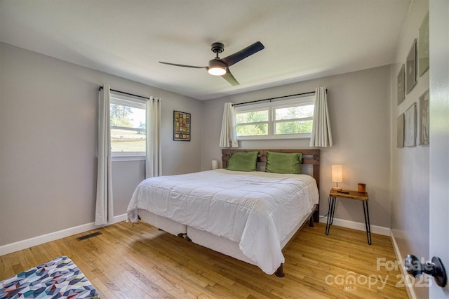 111 Baxter St, Morganton, NC 28655 - bedroom with visible vents, baseboards, wood finished floors, and multiple windows