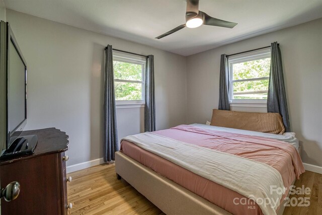 111 Baxter St, Morganton, NC 28655 - bedroom featuring baseboards, a ceiling fan, and light wood-type flooring