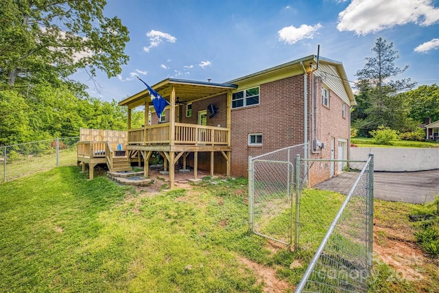 111 Baxter St, Morganton, NC 28655 - back of property featuring driveway, a wooden deck, a gate, a garage, and fence