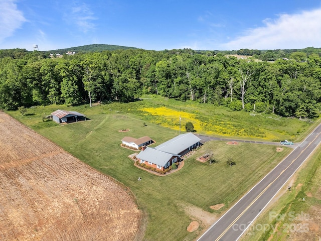 aerial view featuring a wooded view